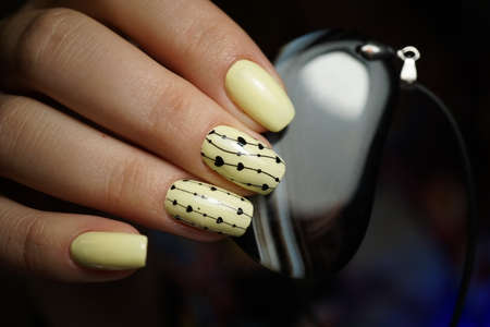 Beautiful bright natural nails with perfect clean manicure. Nail drill machine and cuticle nipper are used simultaneously to make such a clean manicure.の写真素材