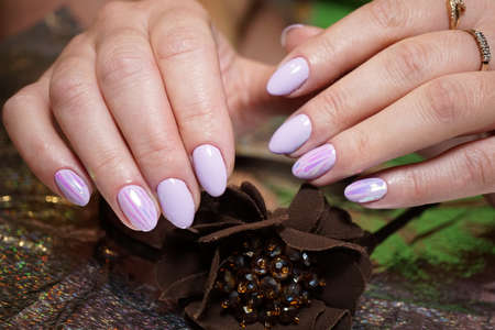 Beautiful bright natural nails with perfect clean manicure. Nail drill machine and cuticle nipper are used simultaneously to make such a clean manicure.の写真素材
