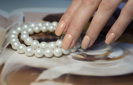 The beauty of the natural nails. Perfect clean manicure for the bright people. Nail drill machine and cuticle nipper are used simultaneously to make such a clean manicure.の写真素材