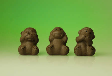 Small clay monkey toy. Three wise monkeys. See no evil, hear no evil, speak no evil.