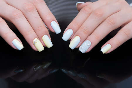 Amazing manicure and natural nails with gel polish. Attractive modern nail art design.の写真素材
