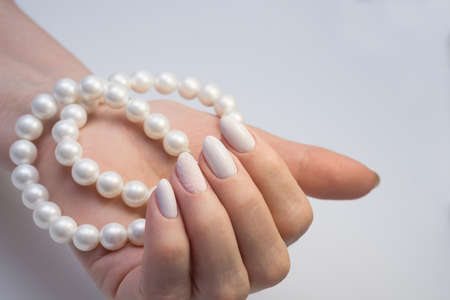 Amazing manicure and natural nails with gel polish. Attractive modern nail art design.の写真素材