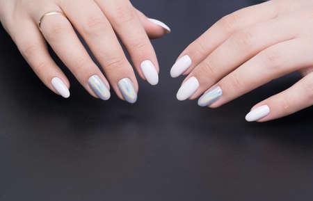 Beautiful natural nails, hand and ideal clean manicure. Decorated with stylish elementsの写真素材