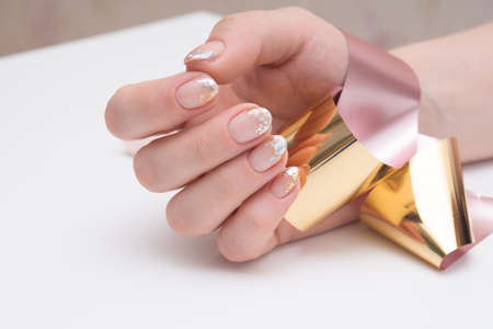 Hands with beautiful manicure. Natural nails with gel polishの写真素材