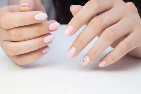 Beautiful manicure and nail art. Natural nails and gel polish.の写真素材