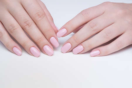 Amazing natural nails. Women's hands with clean manicure. Gel polish applied.の写真素材