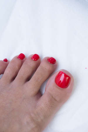 Pedicure and gel polish on women's feet.の写真素材