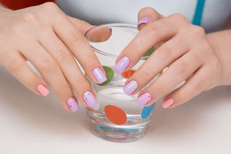 Beautiful natural nails and attractive manicure on women hands.