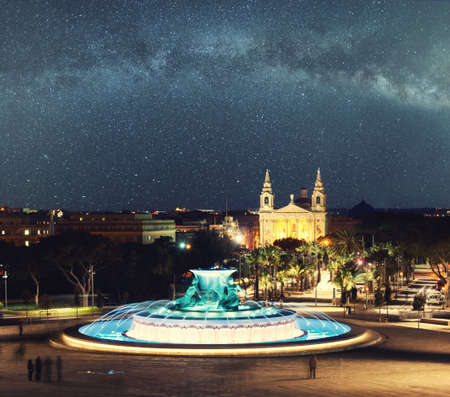 Night view at the Triton Fountain near the city gates of Valletta, Maltaの写真素材