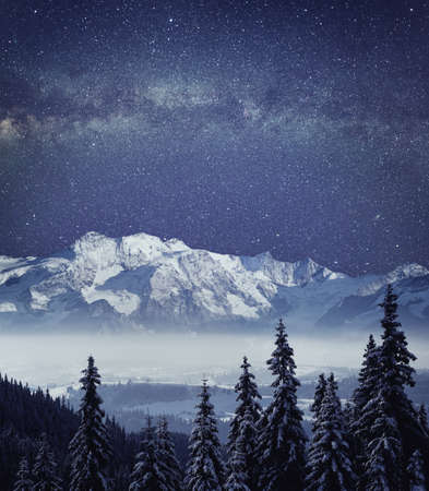 Night mountain winter landscape. Deep night sky with galaxy milky way high resolution panorama.の写真素材