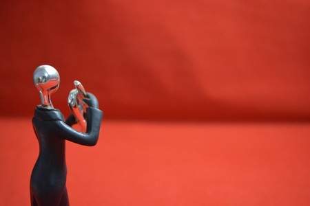 Toy man with a trumpet on red background.の写真素材