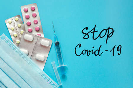 Stop Covid-19. Pills, syringe, medical mask top view. Coronavirus disease treatment. Medicines and...
