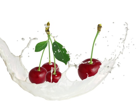 Milk splash with cherries isolated on whiteの写真素材