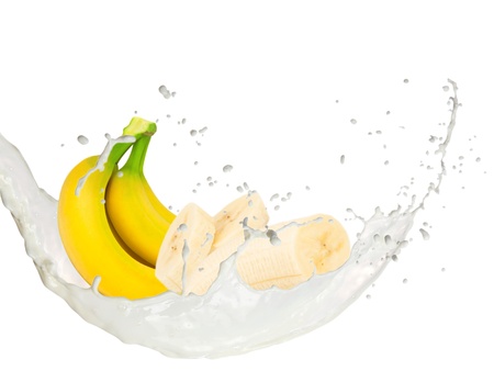 Milk splash with bananas isolated on whiteの写真素材