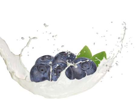 Milk splash with blueberries isolated on whiteの写真素材