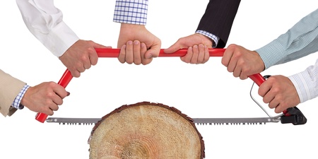 Hands holding saw cutting wood, teamwork conceptの写真素材