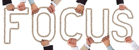 Hands holding rope forming FOCUS tagの写真素材