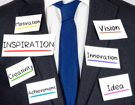 Photo of business suit and tie with INSPIRATION concept paper cardsの写真素材