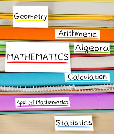 Photo of colorful book stack with bookmarks, labels and MATHEMATICS disciplinesの写真素材