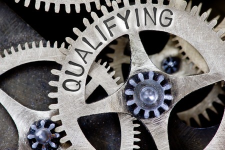 Macro photo of tooth wheel mechanism with QUALIFYING concept lettersの写真素材