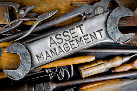 Photo of various tools and instruments with ASSET MANAGEMENT letters imprinted on a clear wrench surfaceの写真素材