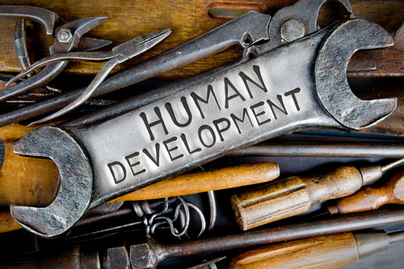 Photo of various tools and instruments with HUMAN DEVELOPMENT letters imprinted on a clear wrench surfaceの写真素材