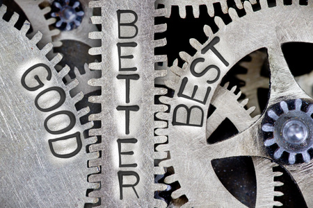 Macro photo of tooth wheel mechanism with imprinted GOOD, BETTER, BEST concept wordsの写真素材