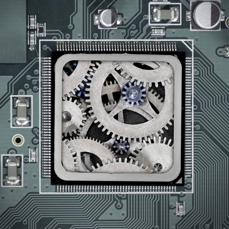 Macro photo of circuit board and chip with cog wheel mechanism; concept of technology connection