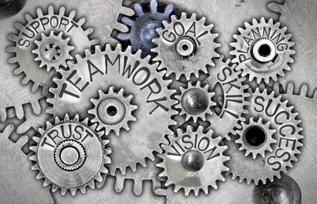 Macro photo of tooth wheels with TEAMWORK concept related words and icons imprinted on metal surfaceの写真素材