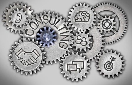 Photo of tooth wheel mechanism with CONSULTING concept related icons imprinted on metal surfaceの写真素材