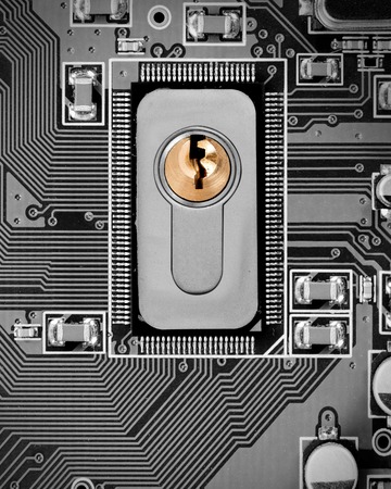 Macro photo of circuit board and chip with lock; concept of cyber securityの写真素材