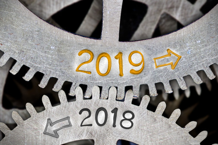 Macro photo of tooth wheel mechanism with numbers 2018, 2019 imprinted on clean metal surface; New Year conceptの写真素材