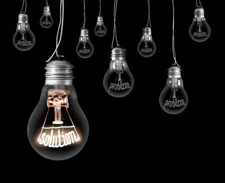 Large group of dark and shining light bulbs with fibers in a shape of Problem and Solution isolated on black backgroundの写真素材