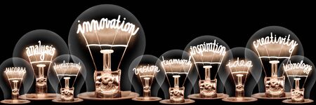 Large group of light bulbs with shining fibers in a shape of Innovation, Inspiration, Creativity and Idea concept related words isolated on black background; horizontal compositionの写真素材