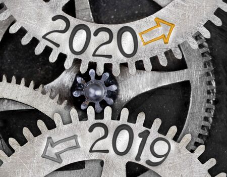 Tooth wheel mechanism with numbers 2020, 2019 imprinted on metal surface. New Year concept.の写真素材