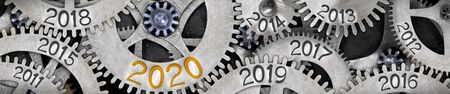 Tooth wheel mechanism with numbers 2020, 2019, 2018 imprinted on metal surface. New Year concept.の写真素材