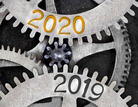 Tooth wheel mechanism with numbers 2020, 2019 imprinted on metal surface. New Year concept.の写真素材