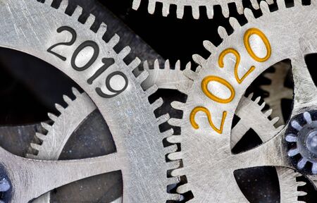 Photo of tooth wheel mechanism with numbers 2020, 2019 imprinted on metal surface. New Year concept.の写真素材