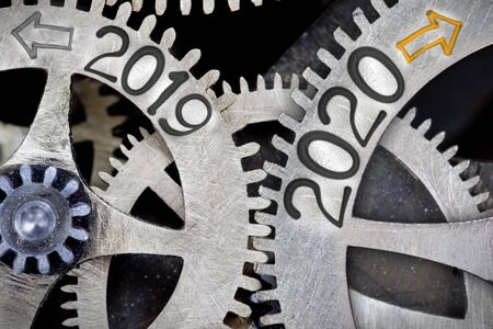 Photo of tooth wheel mechanism with numbers 2020 and 2019 imprinted on metal surface. New Year, Future, Past and Time concept.の写真素材