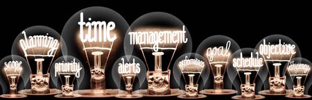 Large group of light bulbs with shining fibers in a shape of Time Management, Scope, Planning and Alerts concept related words isolated on black backgroundの写真素材