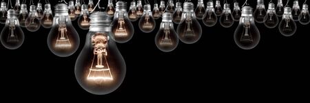 Group of light bulbs going from dark one to a shining one isolated on black background. Concept of Idea, Thinking, Success and Creativity.の写真素材
