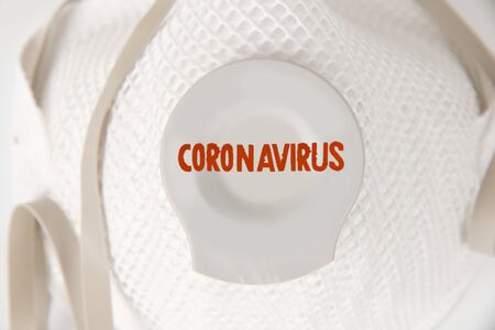 Photo of respirator closeup with red Coronavirus imprintedの写真素材