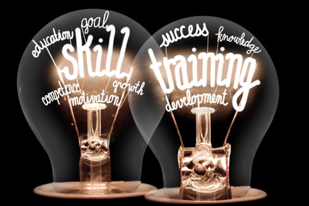 Photo of light bulbs with shining fibers in a shape of Skill Training, Education, Ability and Knowledge concept related words isolated on black backgroundの写真素材