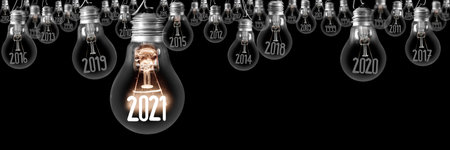 Horizontal group of shining light bulb with fiber in a shape of New Year 2021 and dimmed light bulbs with years passed isolated on black background.の写真素材