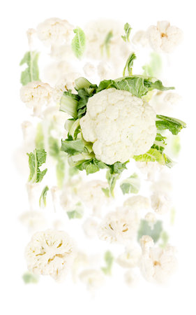Abstract background made of Cauliflower vegetable pieces, slices and leaves isolated on white.の写真素材