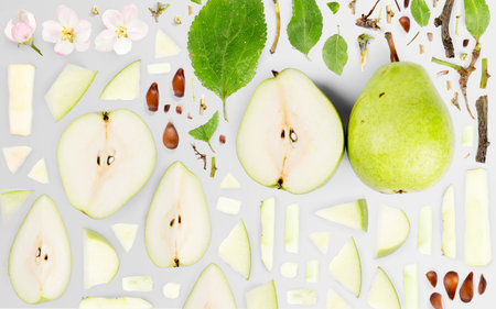 Abstract background made of Pear fruit pieces, slices and leaves isolated on gray background.の写真素材