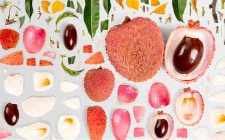 Abstract background made of Litchi fruit pieces, slices and leaves isolated on gray background.の写真素材