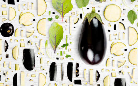Abstract background made of Eggplant vegetable pieces, slices and leaves on wooden background.の写真素材