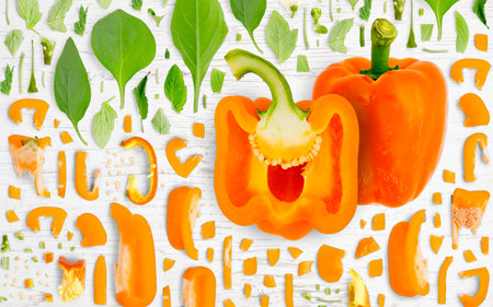 Abstract background made of Orange Pepper vegetable pieces, slices and leaves on wooden background.の写真素材