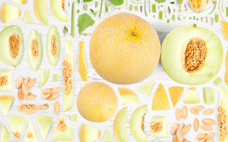 Abstract background made of Sugar Melon fruit pieces, slices and leaves on wooden background.の写真素材